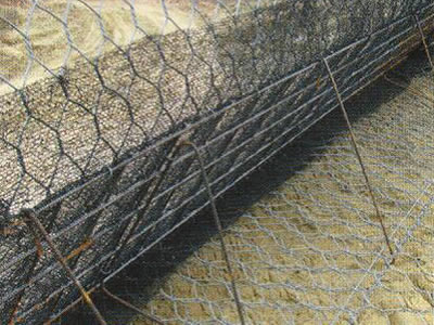 Picture shows structure behind green terramesh, hexagonal wire mesh and fiber blanket lay on ground, hexagonal wire mesh, welded wire mesh, strut as supporting.