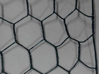 A piece of black reverse twist bilateral PVC coated hexagonal wire mesh.