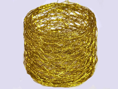 Golden brass hexagonal mesh roll in the form of narrow but long.